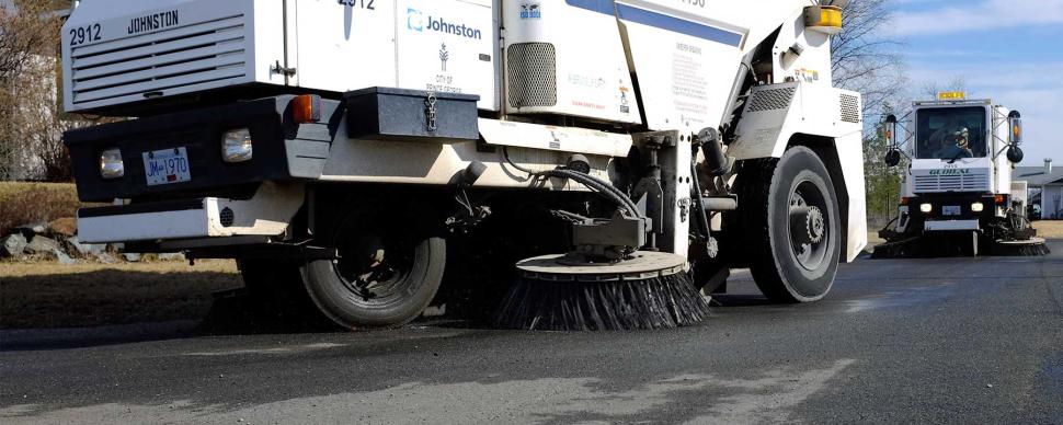 Two street sweepers clearing a road in Prince George.