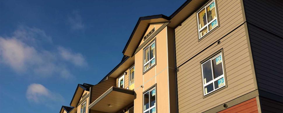 A photograph of a multi-family housing complex under construction.