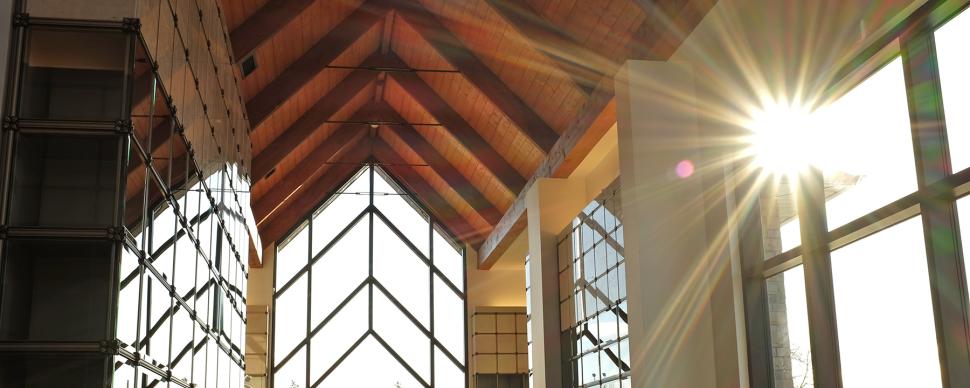 Interior photo of the Memorial Park Cemetery mausoleum with the sun shining through its windows.