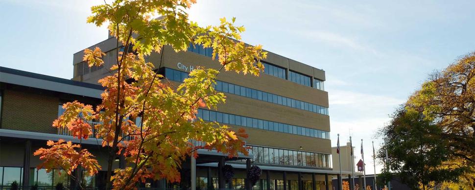 Exterior shot of City Hall in the fall with autumn foliage.
