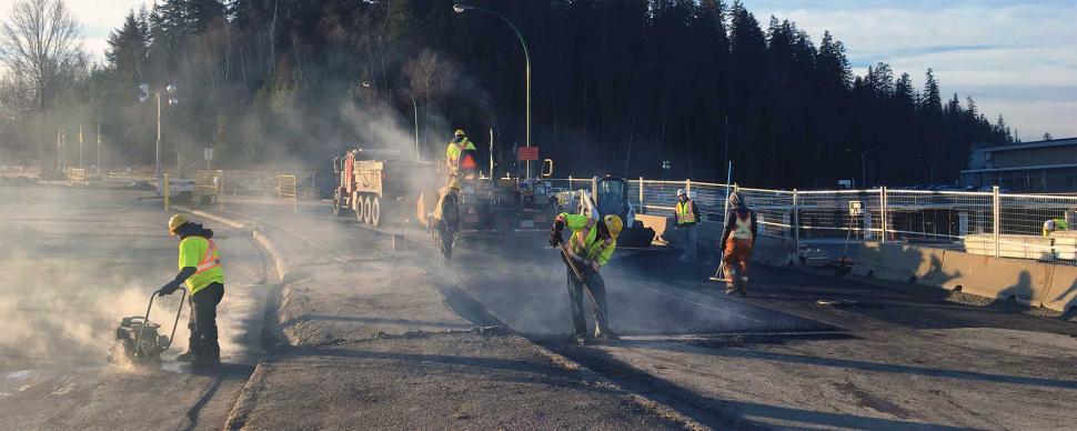 City crews re-paving the road after completing sewer main work.