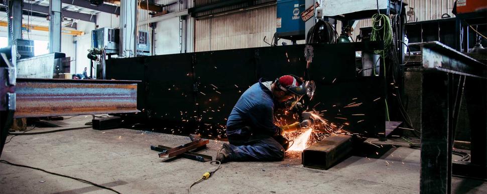 Welder working on a project in a workshop.