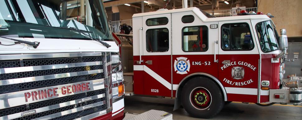 Two red and white fire trucks