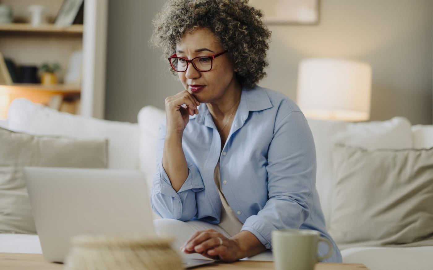 Lady thinking while using laptop